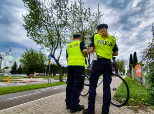 Policjanci stojący przy rowerze.
