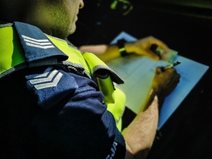 Policjant piszący w notatniku.