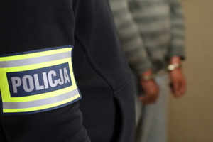 zatrzymany mężczyzna w kajdankach z policjantem